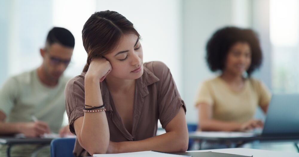 Young female learner distracted in class