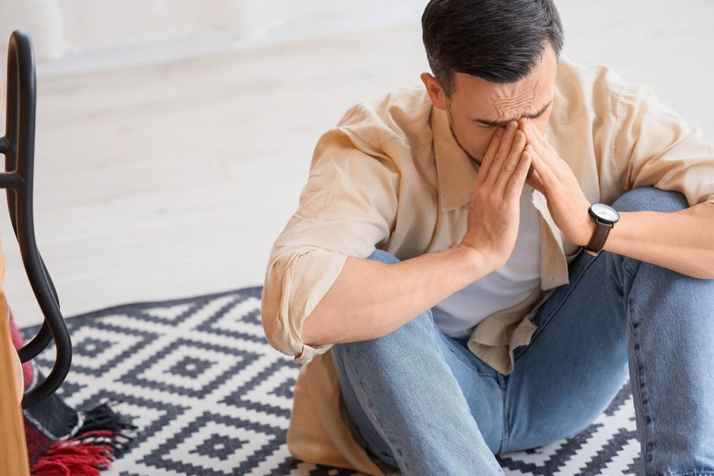 Young man having panic attack in office