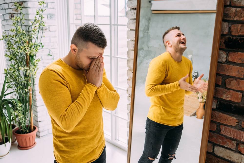 man with bipolar disorder at the mirror