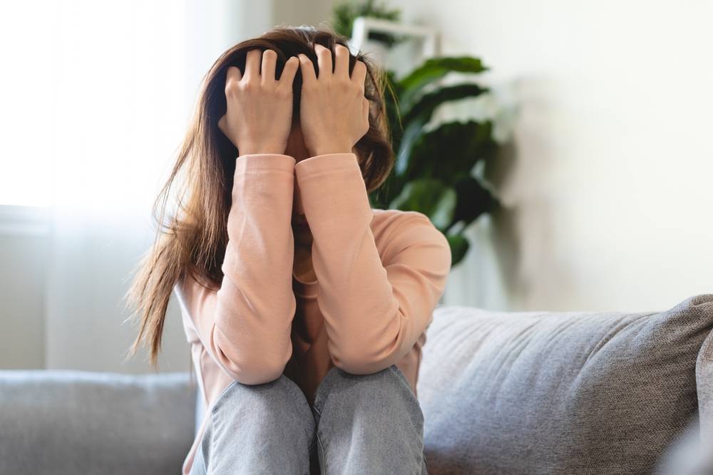 Young women covering her face feeling anxious and unhappy