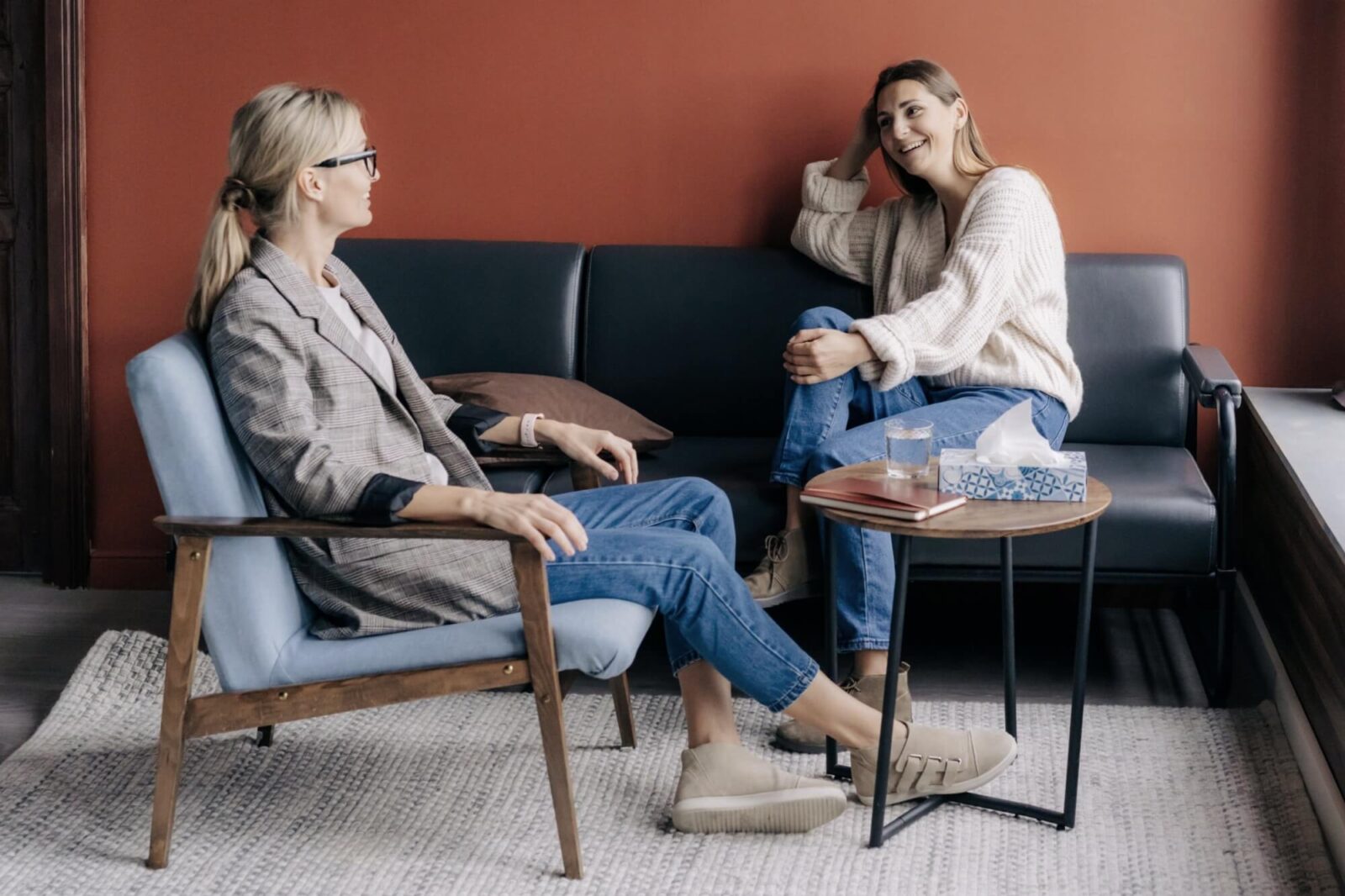 Relaxed young woman talking with therapist in a cozy office