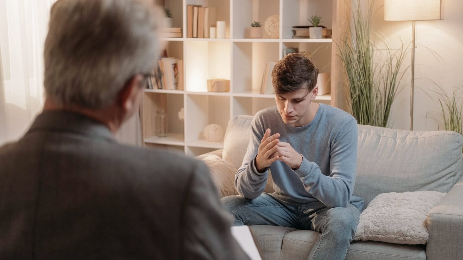 Psychiatrist counseling stressed male patient on consultation treatment