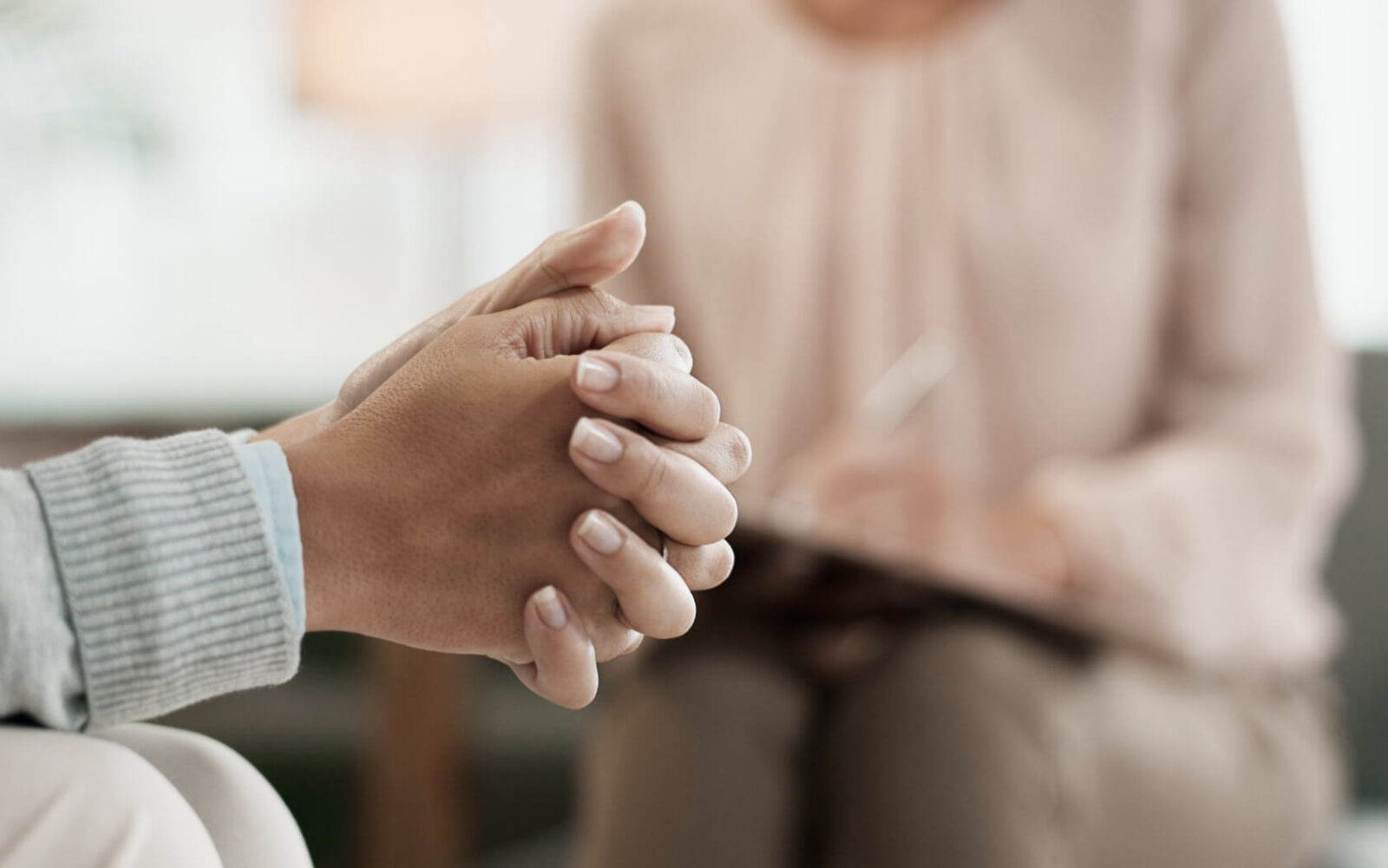 nervous woman with psychologist in consultation office for therapy