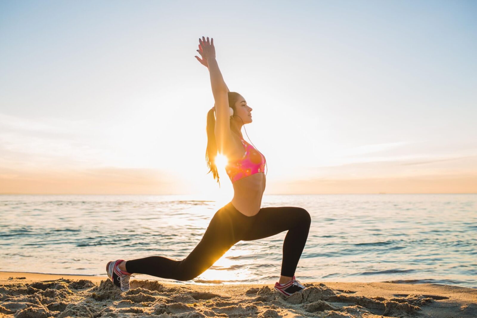 young beautiful woman doing sports on beach