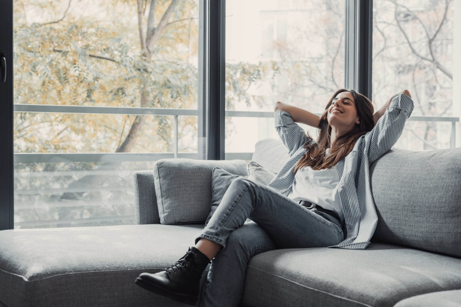 Relaxed pretty young woman feel fatigue lounge on comfortable sofa