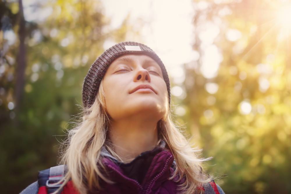 Young woman hiking and going camping in nature