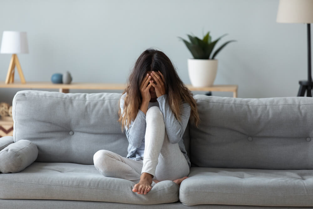 Frustrated woman covering face and crying