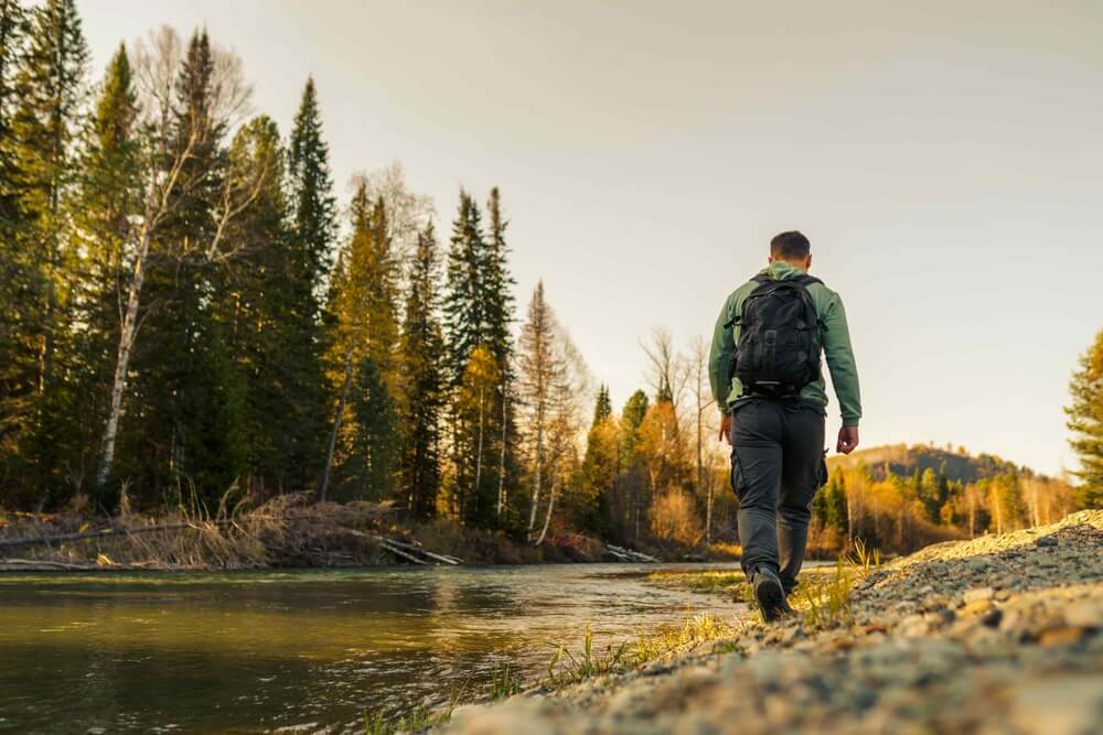 man hiking in the autumn forest